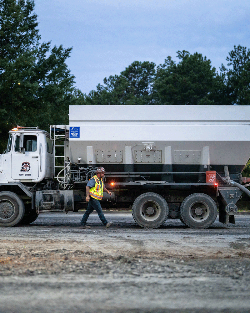 APCC, Employee walking along side truck, early morning, 23137_BUILDWITT_0111