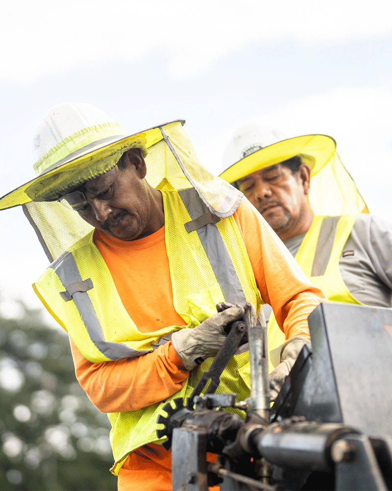 APCC, two employees with large brimmed hard hats working closely, 23137_BUILDWITT_0684